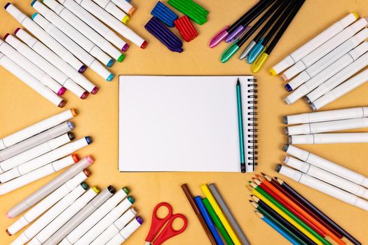 White notebook with a place for inscription on a yellow background. Many different stationery.