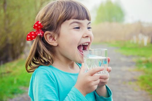 child glass of water. selective focus. Kids.