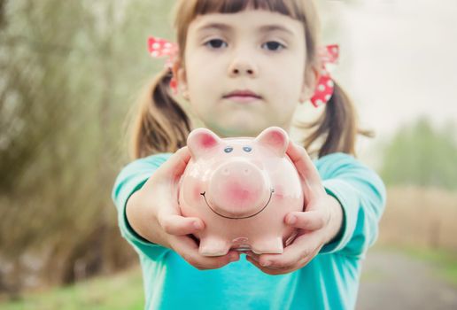 piggy bank in the hands of a child. saving. selective focus.