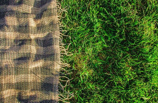 Plaid for a picnic on the grass. Selective focus.