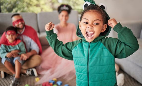 Child, fun and dress up for Halloween with energetic, brave and strong girl playing dress up wearing costume with family at home. Energetic, playful and imagination of kid during pretend game.