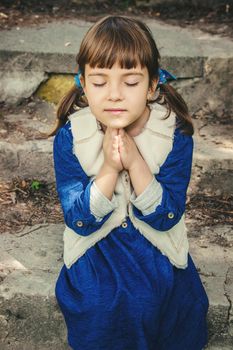 The child prays. Selective focus. People kids.
