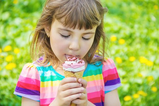 The child eats ice cream. Selective focus.