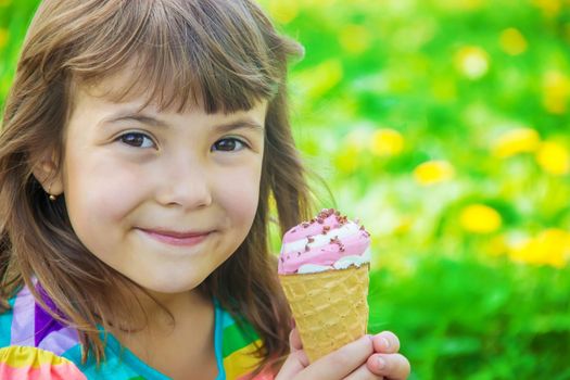 The child eats ice cream. Selective focus.
