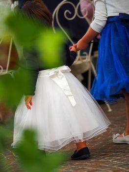 Beautiful baby girl in a blue dress running