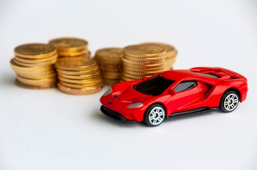 Kuala Lumpur, Malaysia - September 2022 : Miniature toy car of Ford GT with gold coin background. Copy space.