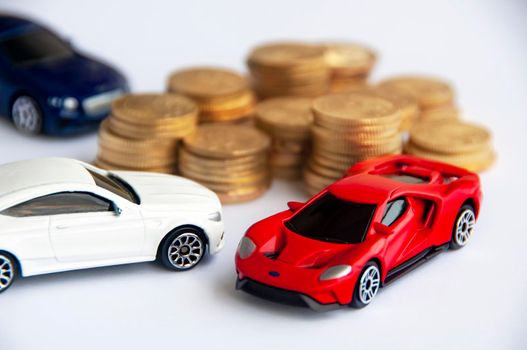 Kuala Lumpur, Malaysia - September 2022 : Miniature toy car of Mercedes AMG, Ford Gt and Bentley Continental GT with blurred gold coin background. Copy space