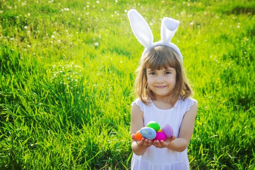 Child with rabbit ears. Easter. Selective focus.