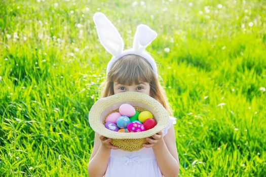 Child with rabbit ears. Easter. Selective focus nature