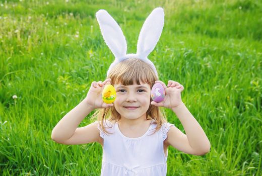 Child with rabbit ears. Easter. Selective focus nature