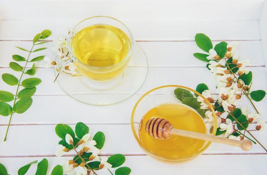 Honey with acacia and tea. Selective focus.