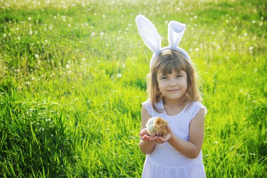 Child with rabbit ears. Easter. Selective focus.