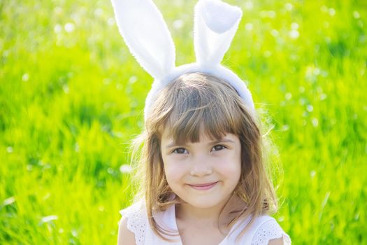 Child with rabbit ears. Easter. Selective focus nature