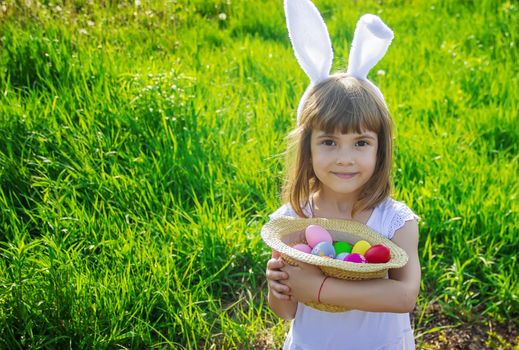 Child with rabbit ears. Easter. Selective focus.