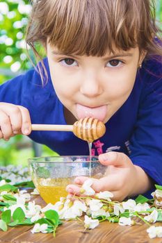 The child eats honey. Selective focus. nature nature