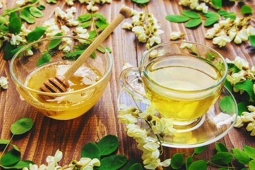 Honey with acacia and tea. Selective focus.