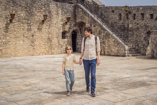 Father and son tourists in Herceg Novi old town. Historical and touristic center of Herceg Novi. Montenegro.