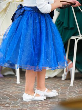 Beautiful baby girl in a blue dress running