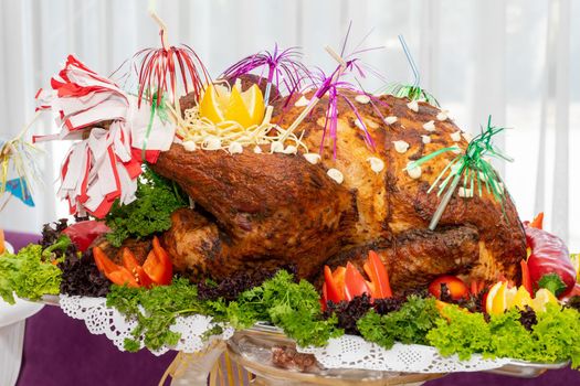 A large roast turkey on the holiday table at Thanksgiving