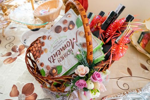 Festive basket with wine and sweets. Ukraine, Vinnytsia, 19082021.