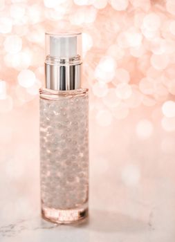 Cosmetic branding, blank label and glamour present concept - Holiday make-up base gel, serum emulsion, lotion bottle and rose gold glitter, luxury skin and body care cosmetics for beauty brand ads