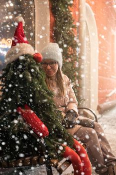 Pretty woman with fir tree decorated mannequin. Xmas holidays, New Year or Christmas concept