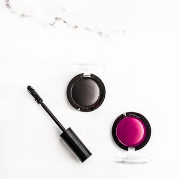 Cosmetic branding, blog and girly concept - Eyeshadows, black liner and mascara on marble background, eye shadows cosmetics as glamour make-up products for luxury beauty brand, holiday flatlay design