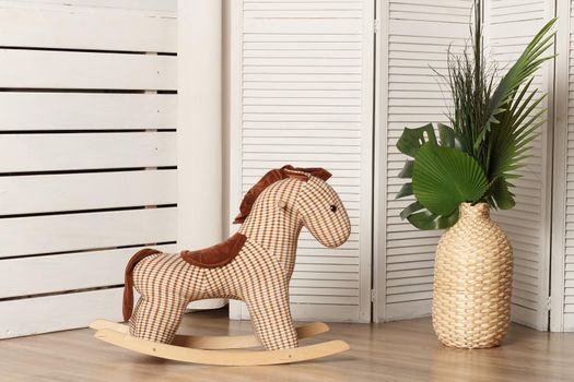 Brown rag horse for a rocking chair in the interior