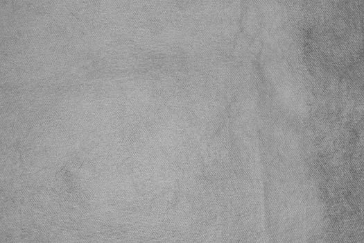 Texture of non-woven material in gray. Background for copy spaced designs.