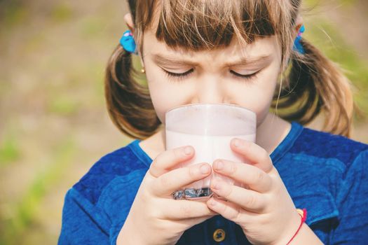 The child drinks milk. Selective focus. Kids.