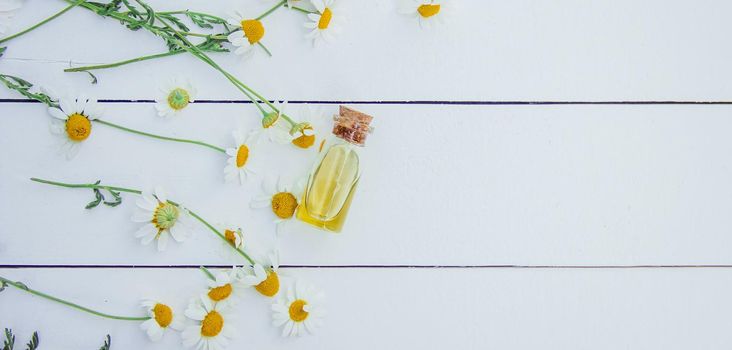 Chamomile extract in a small bottle. Selective focus.