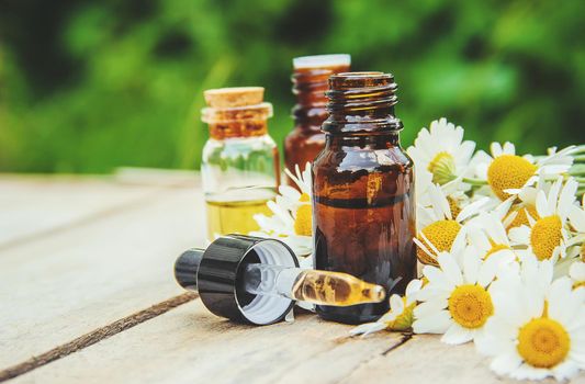 Chamomile extract in a small bottle. Selective focus.