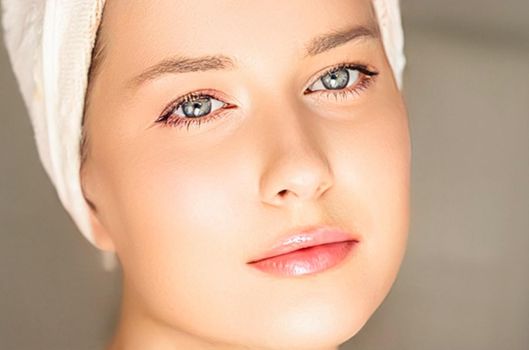 Skin care and beauty routine, beautiful woman with white towel wrapped around head, skincare cosmetics and face cosmetology, close-up portrait