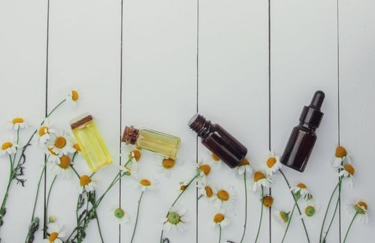 Chamomile extract in a small bottle. Selective focus.