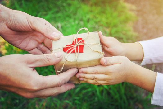 gift in the hands of a child. congratulations on his father's day.