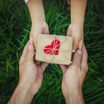 gift in the hands of a child. congratulations on his father's day.