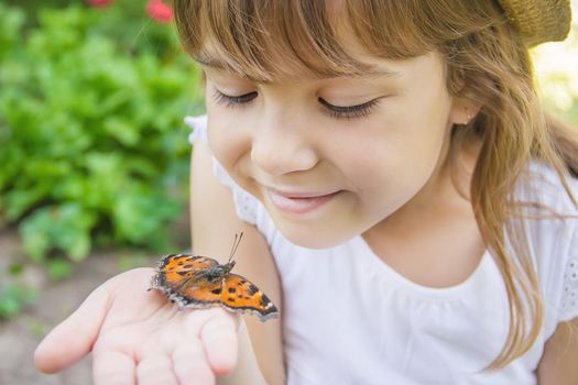 Child with a butterfly. Idea leuconoe. Selective focus.