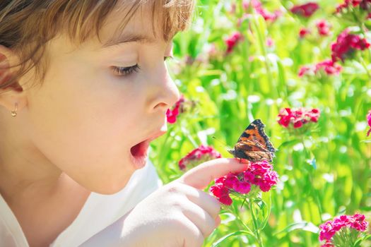 Child with a butterfly. Idea leuconoe. Selective focus.