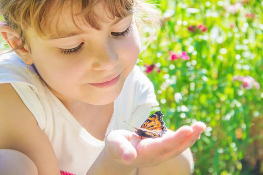 Child with a butterfly. Idea leuconoe. Selective focus.