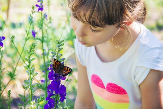 Child with a butterfly. Idea leuconoe. Selective focus.