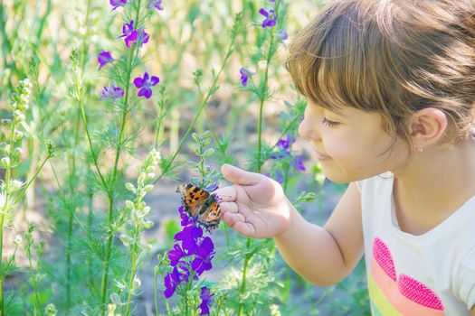 Child with a butterfly. Idea leuconoe. Selective focus.