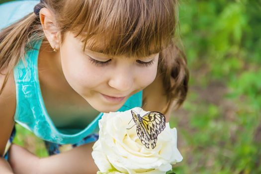 Child with a butterfly. Idea leuconoe. Selective focus.