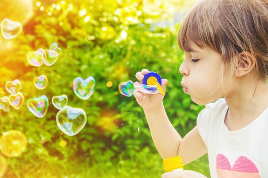 The children are blowing bubbles. Selective focus.