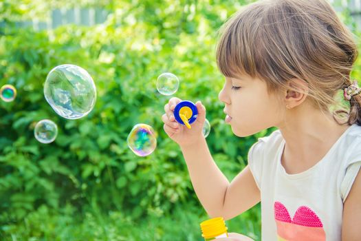 The children are blowing bubbles. Selective focus.