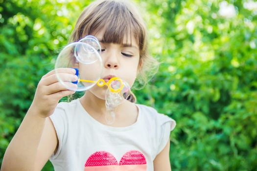 The children are blowing bubbles. Selective focus.