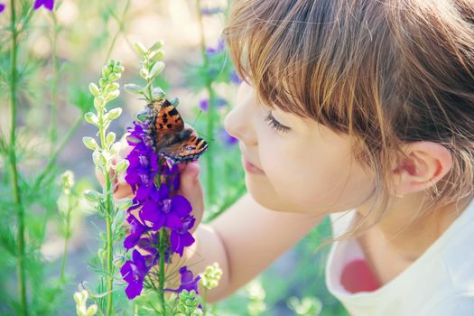 Child with a butterfly. Idea leuconoe. Selective focus.