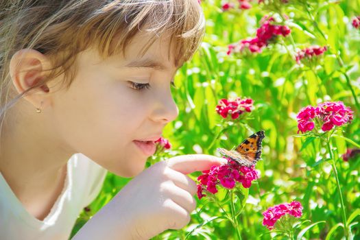 Child with a butterfly. Idea leuconoe. Selective focus.