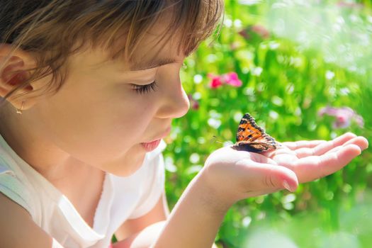 Child with a butterfly. Idea leuconoe. Selective focus.