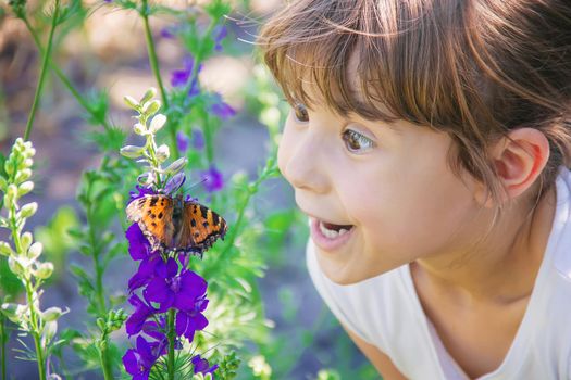 Child with a butterfly. Idea leuconoe. Selective focus.