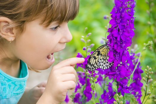 Child with a butterfly. Idea leuconoe. Selective focus.